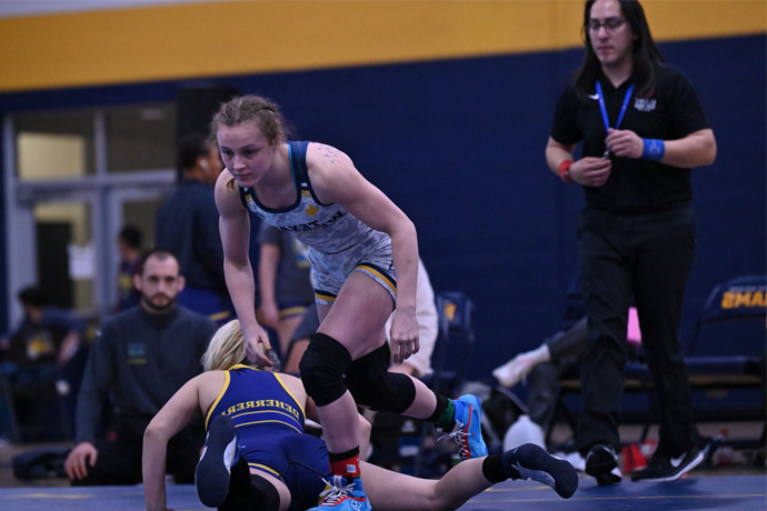 Texas Wesleyan Wrestler Lexie Basham celebrating in the Sid Richardson Center after a win over an opponent