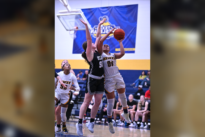 TXWES women's basketball player Makayla Coy jumping for a rebound during a basketball game