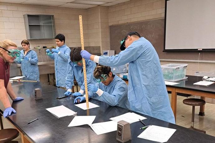 Upward Bound students work together on a project in a lab